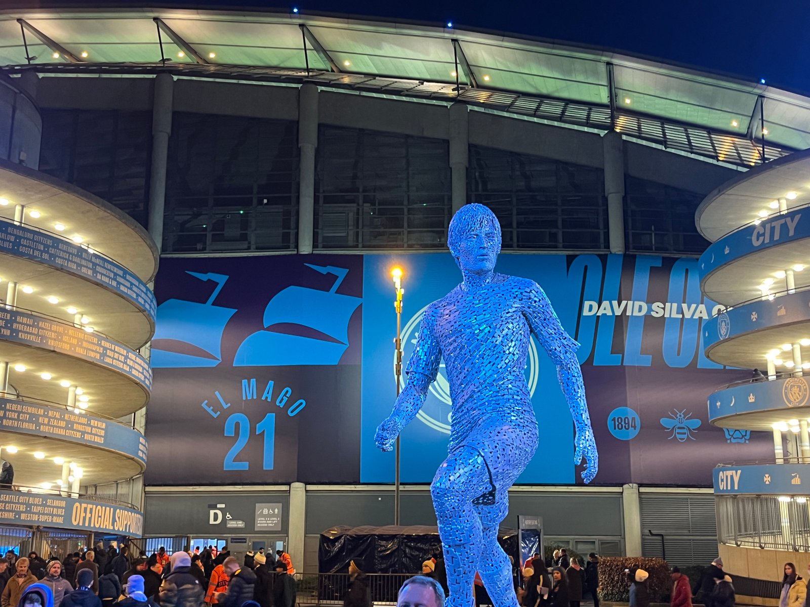 Etihad Stadium exterior and Manchester City supporters on matchday